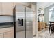 Modern kitchen featuring stainless steel appliances, light wood cabinets, and open access to the dining area at 8500 E Jefferson Ave # 3H, Denver, CO 80237