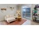 Bright living room with a sectional sofa and sliding glass doors leading to an outdoor balcony at 8500 E Jefferson Ave # 3H, Denver, CO 80237