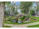 Beautifully landscaped pond with mature trees creates a serene environment near well-maintained homes at 8500 E Jefferson Ave # 3H, Denver, CO 80237
