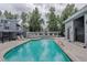 Community pool surrounded by lounge chairs and mature trees for relaxation and enjoyment at 8500 E Jefferson Ave # 3H, Denver, CO 80237