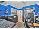 Bedroom with bold blue walls, an open closet, and a wooden dresser at 11833 Oak Hill Way # E, Commerce City, CO 80640