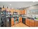 Kitchen featuring stainless steel appliances, wood cabinets, and ample counter space at 11833 Oak Hill Way # E, Commerce City, CO 80640