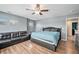 Main bedroom with a ceiling fan, multiple windows for natural light, and a leather sofa at 11833 Oak Hill Way # E, Commerce City, CO 80640