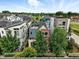 Eye-level aerial view of a residential community with a lake and modern townhomes at 1376 Snowberry Ln, Louisville, CO 80027