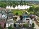 Aerial view of a neighborhood showcasing diverse home styles, mature trees, and a scenic lake at 1376 Snowberry Ln, Louisville, CO 80027