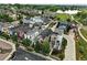 Aerial view of a residential neighborhood with diverse home styles, trees, and a lake at 1376 Snowberry Ln, Louisville, CO 80027