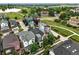 A high-angle aerial shot showcases the home's position near a pond with walking trails at 1376 Snowberry Ln, Louisville, CO 80027