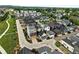 Community aerial shot showcasing a suburban neighborhood with modern homes and manicured lawns at 1376 Snowberry Ln, Louisville, CO 80027