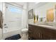 Bright bathroom featuring a shower-tub, modern fixtures, and vanity at 1376 Snowberry Ln, Louisville, CO 80027