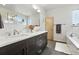 Bathroom featuring a double vanity, soaking tub, and modern fixtures and finishes at 1376 Snowberry Ln, Louisville, CO 80027