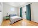 Cozy bedroom with hardwood floors, natural light, and serene decor at 1376 Snowberry Ln, Louisville, CO 80027