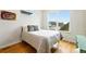 Bright bedroom featuring a large window, hardwood floors, and modern decor at 1376 Snowberry Ln, Louisville, CO 80027