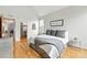 Bedroom with hardwood floors has access to a walk-in closet and ensuite bathroom at 1376 Snowberry Ln, Louisville, CO 80027