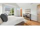 Bright bedroom with a large window, hardwood floors, and stylish decor at 1376 Snowberry Ln, Louisville, CO 80027
