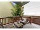 Relaxing deck features wooden furniture and a view of mature trees and greenery at 1376 Snowberry Ln, Louisville, CO 80027