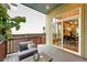 Relaxing deck features wooden furniture and a view to dining room, mature trees and greenery at 1376 Snowberry Ln, Louisville, CO 80027