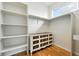 Spacious walk-in closet with built-in shelving, ample storage space, and hardwood floors at 1376 Snowberry Ln, Louisville, CO 80027