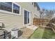 Backyard view featuring artificial grass, rock landscaping, fence, and sliding glass door at 7822 S Kittredge Cir, Englewood, CO 80112