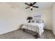 Comfortable bedroom with a ceiling fan, a large window, and plush carpeting at 7822 S Kittredge Cir, Englewood, CO 80112
