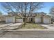 Charming townhome with attached garages, well-maintained landscaping, and mature tree at 7822 S Kittredge Cir, Englewood, CO 80112