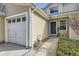 Well-maintained home featuring an attached garage, neutral siding, and a welcoming entrance at 7822 S Kittredge Cir, Englewood, CO 80112