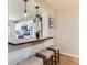 Modern kitchen with stainless steel appliances and a breakfast bar with seating at 7822 S Kittredge Cir, Englewood, CO 80112