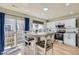 Eat-in kitchen featuring white cabinetry, stainless steel appliances, and sliding glass doors to yard at 7822 S Kittredge Cir, Englewood, CO 80112