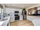 Well-lit kitchen featuring white cabinets, stainless steel appliances, and breakfast nook access at 7822 S Kittredge Cir, Englewood, CO 80112