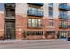 Brick apartment building exterior with private balconies and secure entry at 3500 S Corona St # 205, Englewood, CO 80113