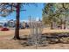 Disc golf course with basket, set among mature trees at 3500 S Corona St # 205, Englewood, CO 80113