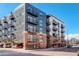 Modern multi-story apartment building with brick facade and private balconies at 3500 S Corona St # 205, Englewood, CO 80113