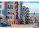 Apartment building view from street, with retail below and balconies above at 3500 S Corona St # 205, Englewood, CO 80113