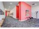 Inviting hallway with contemporary art, seating, and vibrant accent wall at 3500 S Corona St # 205, Englewood, CO 80113