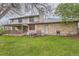 Expansive backyard with a covered patio, lush green lawn, and mature trees at 8075 S Harrison Way, Centennial, CO 80122