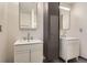 Modern bathroom featuring double sinks with illuminated mirrors and gray shower stall at 8075 S Harrison Way, Centennial, CO 80122