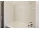Clean white bathtub and shower combo with white tile at 8075 S Harrison Way, Centennial, CO 80122