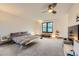 Modern bedroom featuring a large window, ceiling fan, and sleek minimalist furnishings at 8075 S Harrison Way, Centennial, CO 80122