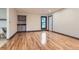 Spacious living room with hardwood floors, a wet bar, white walls and contrasting window trim and baseboards at 8075 S Harrison Way, Centennial, CO 80122