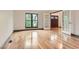 Bright living room features gleaming hardwood floors, large window and glass paneled doors at 8075 S Harrison Way, Centennial, CO 80122