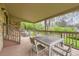 Covered patio area with outdoor dining set and railing at 8075 S Harrison Way, Centennial, CO 80122
