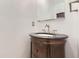 Close-up of a powder room with a pedestal sink, silver faucet and a dark granite countertop at 8075 S Harrison Way, Centennial, CO 80122