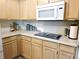 Efficient kitchen space with ample counter space, modern appliances, and light wood cabinetry at 5860 W 115Th Ave, Westminster, CO 80020