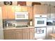 Functional kitchen with microwave, oven, and neutral countertops and cabinetry at 5860 W 115Th Ave, Westminster, CO 80020