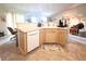 Open kitchen view featuring a breakfast bar, modern appliances, and tile flooring at 5860 W 115Th Ave, Westminster, CO 80020