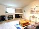 Bright living room with a cozy fireplace, built-in shelving, and comfortable seating at 5860 W 115Th Ave, Westminster, CO 80020