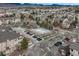 Aerial view of community pool, parking and buildings with mountain backdrop at 9568 W San Juan Cir # 203, Littleton, CO 80128