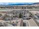 Aerial view of a multi-unit residential complex with parking, landscaping, and mountain backdrop at 9568 W San Juan Cir # 203, Littleton, CO 80128