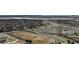 Expansive aerial view showcasing the neighborhood's track, pool, and proximity to major roadways and a scenic lake at 9568 W San Juan Cir # 203, Littleton, CO 80128