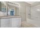 Well-lit bathroom with a granite countertop vanity and a bathtub with a shower, providing functionality and style at 9568 W San Juan Cir # 203, Littleton, CO 80128