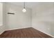 This dining room features hardwood floors and a modern light fixture to create a pleasant, refined aesthetic at 9568 W San Juan Cir # 203, Littleton, CO 80128